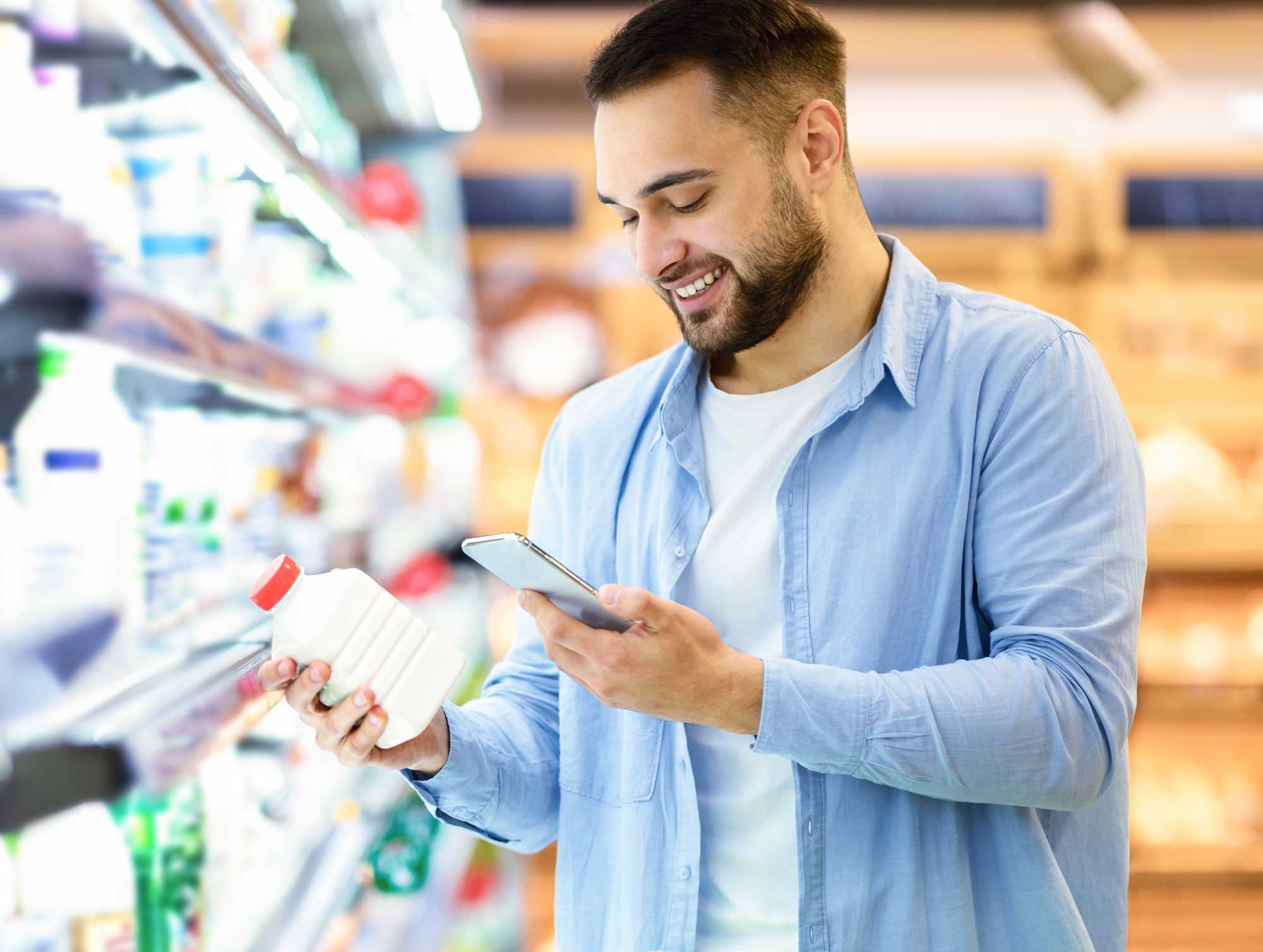 man-scanning-code-on-products-using-smartphone-2025-03-18-15-47-49-utc XRS Retail Inc - A Better, Smarter Way To Merchandise